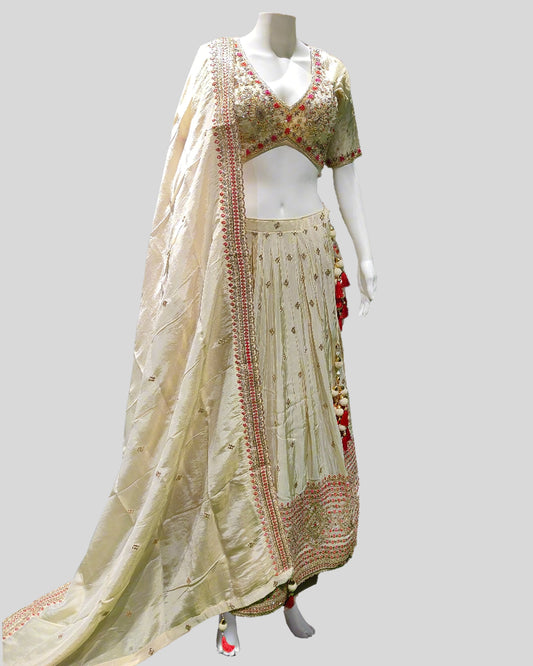 Cream & Red Bridal Lehenga Choli – Hand-Embroidered Floral Motifs with Tassel Accents