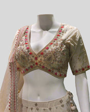 Cream & Red Bridal Lehenga Choli – Hand-Embroidered Floral Motifs with Tassel Accents